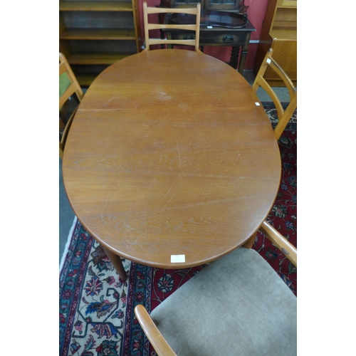 32 - A teak extending dining table and four chairs