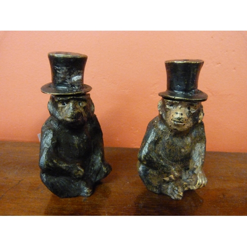 370 - A pair of painted bronze monkey pepperettes