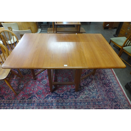 51 - A teak drop leaf dining table and four McIntosh dining chairs