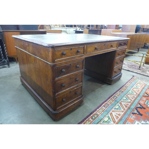 82 - A Victorian oak and green leather topped partners library desk