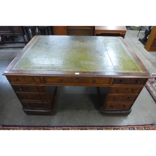 82 - A Victorian oak and green leather topped partners library desk