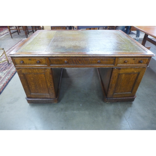 82 - A Victorian oak and green leather topped partners library desk