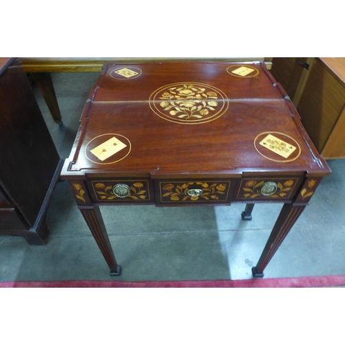 94 - A 19th Century Dutch marquetry inlaid fold over games table