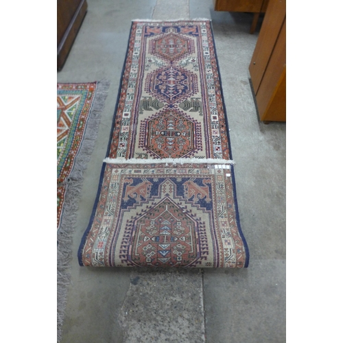 99 - An eastern beige ground runner rug, 286 x 77cms