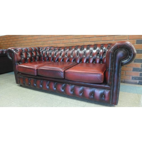 2 - An oxblood red leather Chesterfield settee