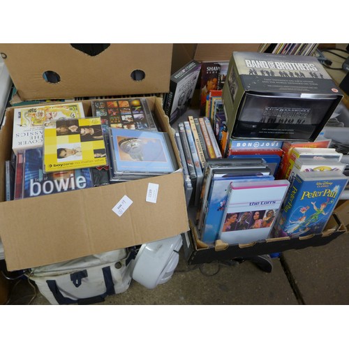 2239 - Two boxes of DVDs, VHS videos and CDs including Disney, pop and rock CDs, etc.