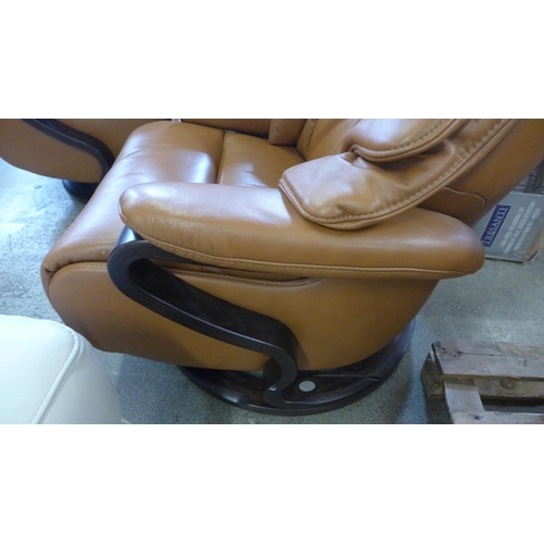 1529 - A tan leather swivel reclining chair