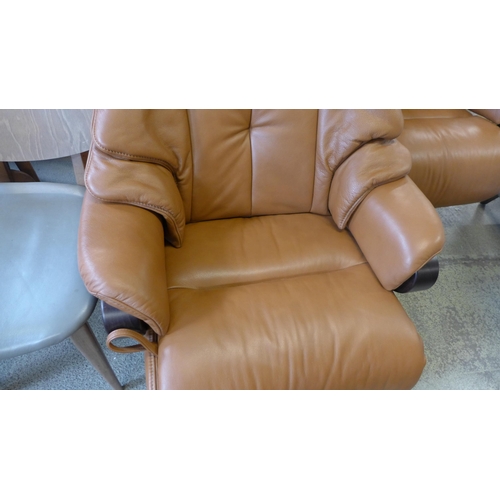 1530 - A tan leather swivel reclining chair