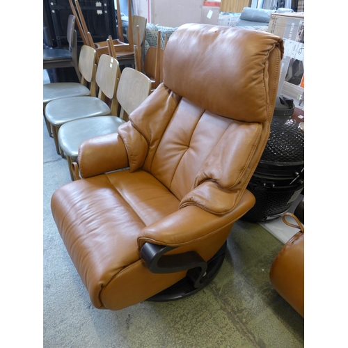 1530 - A tan leather swivel reclining chair