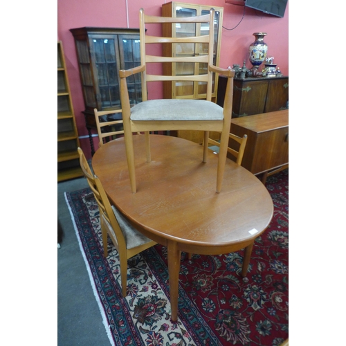 28 - A teak extending dining table and four chairs