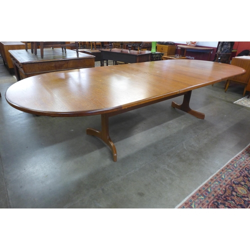 23 - A large G-Plan Fresco teak extending dining table, 73cms h, 232cms l (303cms l), 117cms w