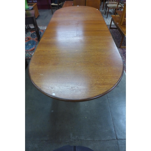 23 - A large G-Plan Fresco teak extending dining table, 73cms h, 232cms l (303cms l), 117cms w