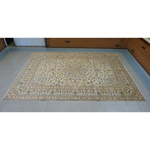 116 - A Persian cream ground Kashan rug, 399 x 284cms