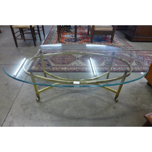 123 - An Italian style brass and oval glass topped coffee table