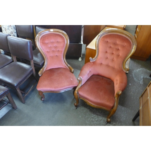 150 - A pair of Victorian lady's and gentleman's mahogany and upholstered spoonback armchairs