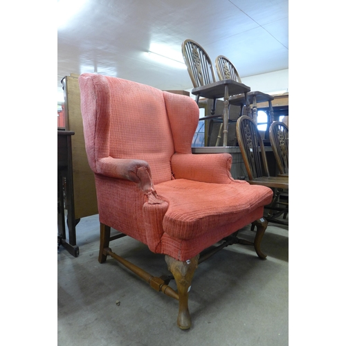 185 - An early 20th Century Queen Anne style walnut and fabric upholstered wingback armchair