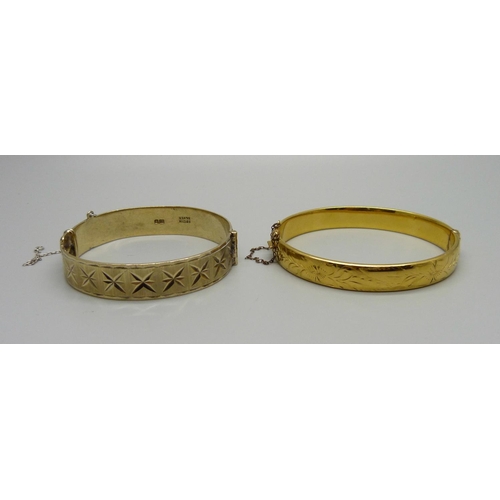 1014 - A silver gilt bangle and a gold plated bangle