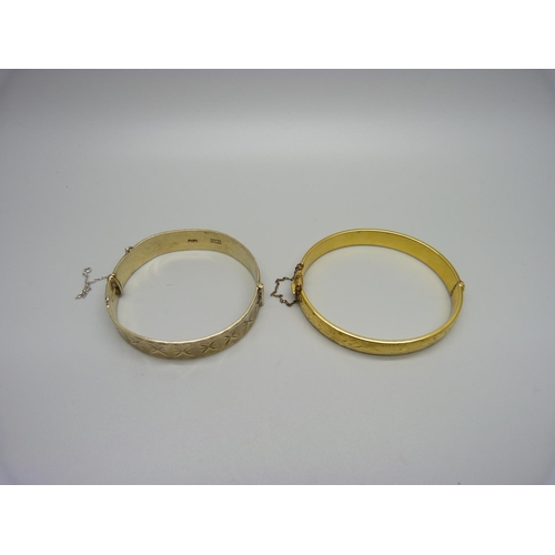 1014 - A silver gilt bangle and a gold plated bangle