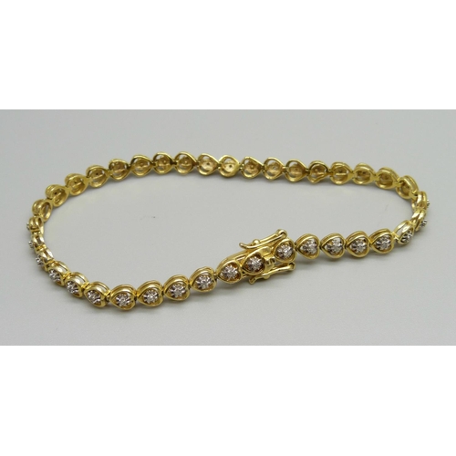 1021 - A silver gilt and diamond bracelet