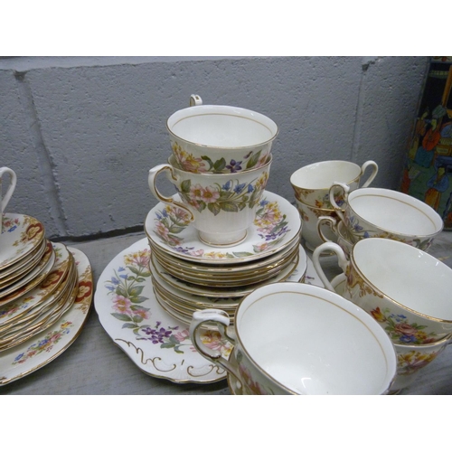 1069 - A Paragon Country Lane six setting tea service, a Windsor tea service, lacking sugar bowl, and a gre... 