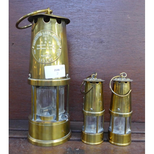 604 - An Eccles miner’s safety lamp and two smaller lamps