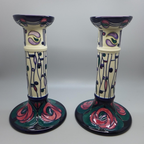 613 - A pair of Moorcroft Mack candlesticks, boxed, 21cm