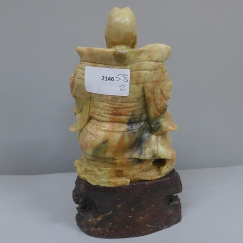 637 - A carved soapstone figure, 20.5cm