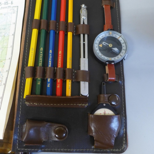 661 - A Soviet map case, with pencils, wrist compass and maps