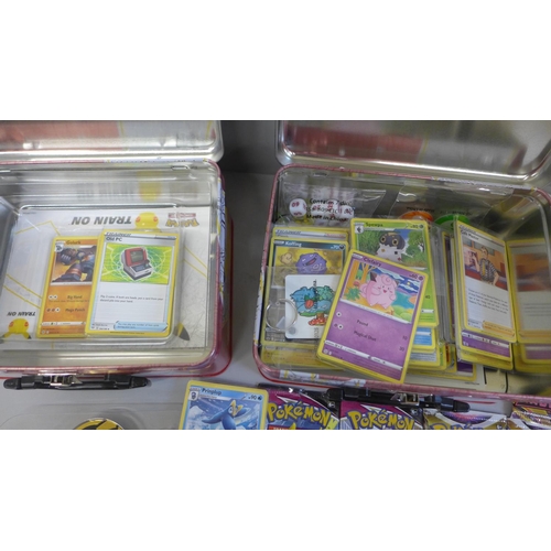 709 - A collection of various Pokemon cards and coins, folders, keyrings, a poster, etc.