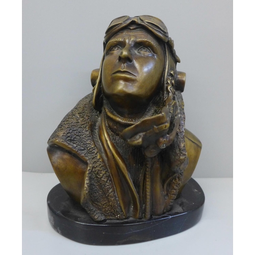 716 - A 20th Century bronze bust of a fighter pilot, signed RS on black marble base, 18.5cm