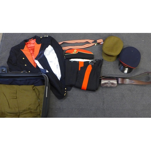 739 - A case containing two Royal Artillery uniforms