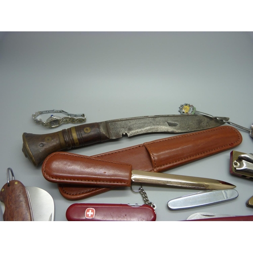 829 - A collection of penknives, a letter opener, a harmonica, etc.