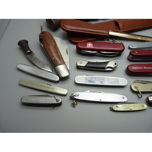 829 - A collection of penknives, a letter opener, a harmonica, etc.