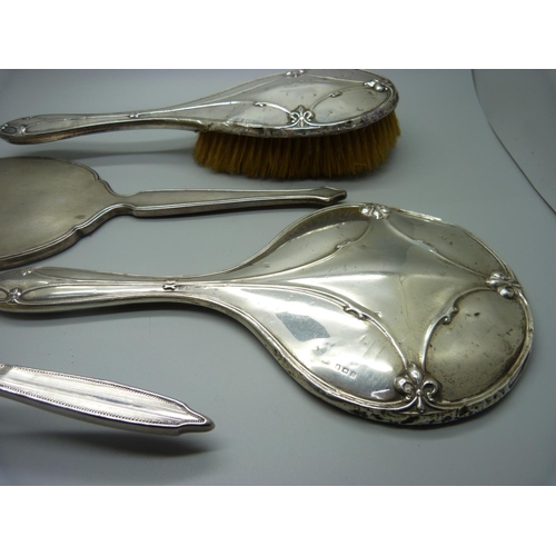 853 - A silver backed mirror, two silver backed brushes, a/f, and a silver mirror back for scrap