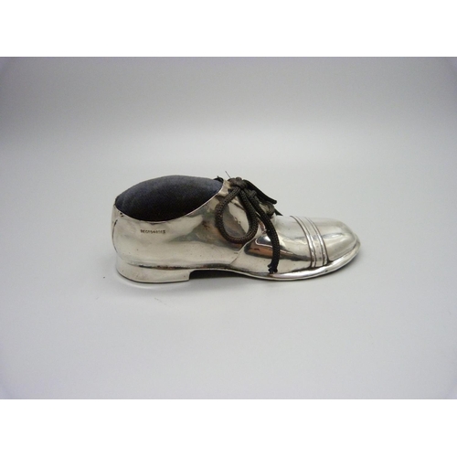 858 - A novelty silver shoe pin cushion, worn Chester hallmark, 12cm