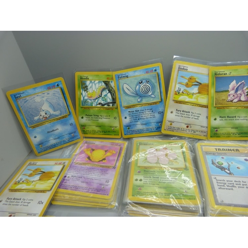 859 - 166 Pokemon cards, 57 base set, 67 jungle set, 31 fossil set and 11 team rocket set