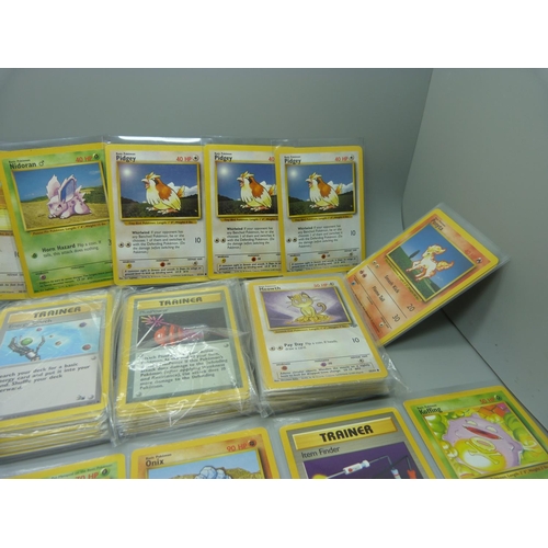 859 - 166 Pokemon cards, 57 base set, 67 jungle set, 31 fossil set and 11 team rocket set