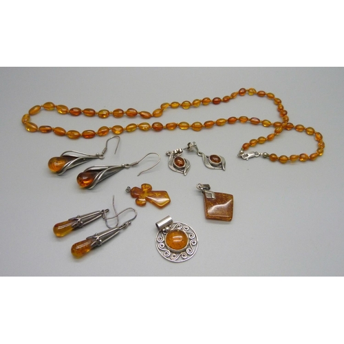 877 - A collection of amber jewellery, some silver mounted