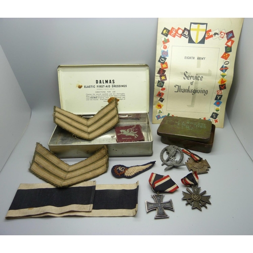 883 - A collection of WWII period military items, including three German cross medals, a German anti-aircr... 