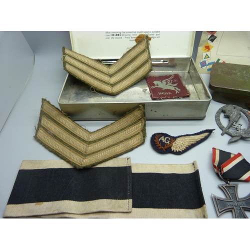 883 - A collection of WWII period military items, including three German cross medals, a German anti-aircr... 