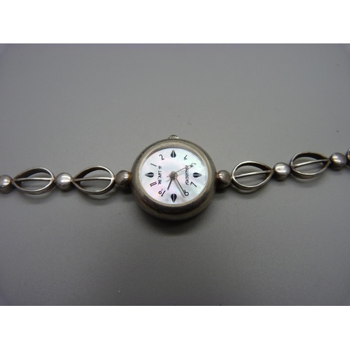 892 - A silver Rennie Mackintosh wristwatch and a brooch