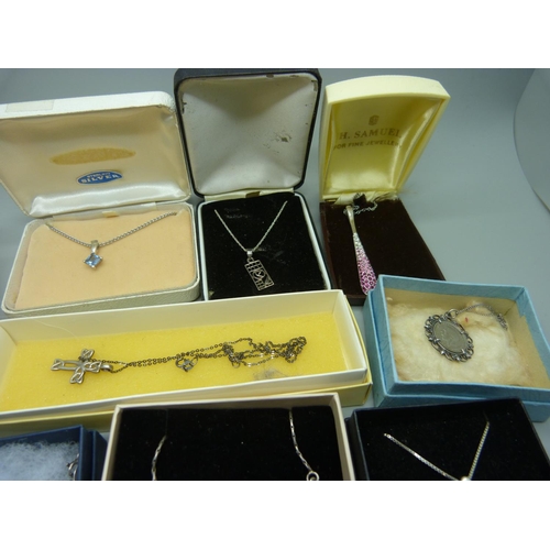 898 - Ten silver pendants and chains