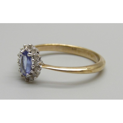 920 - A 9ct gold, tanzanite and diamond cluster ring, 2.1g, P