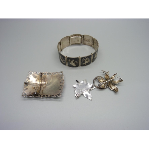 944 - A Thai silver bracelet and brooch and two other silver brooches