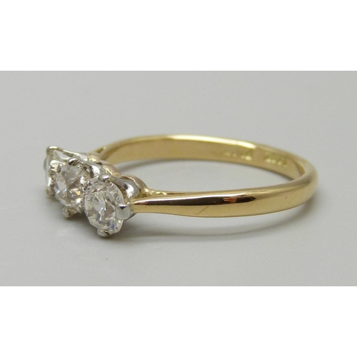 972 - An 18ct gold and platinum set three stone diamond ring, total diamond weight 0.8ct, 2.9g, N