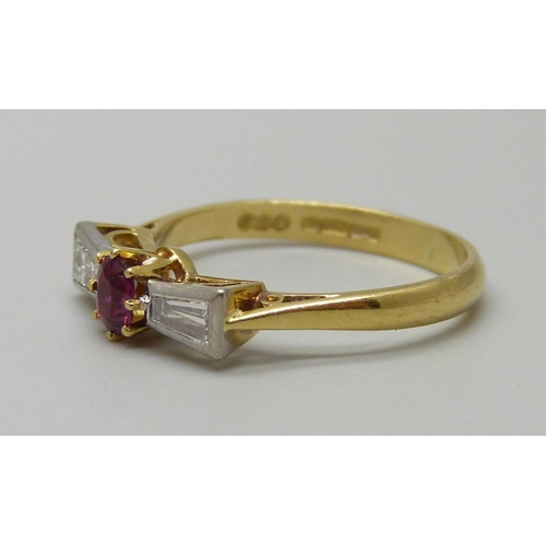 975 - An 18ct gold, ruby and trapeze cut diamond ring, Birmingham 1982, 3.2g, O