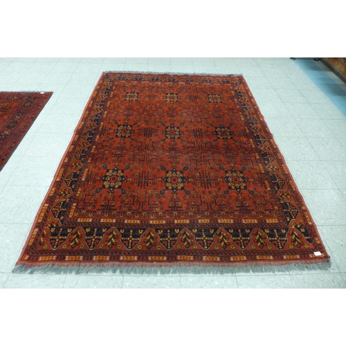 118 - A hand knotted red ground rug, 246 x 176cms