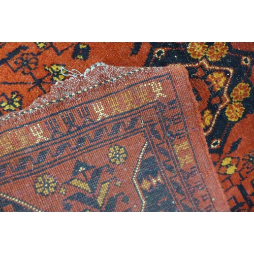 118 - A hand knotted red ground rug, 246 x 176cms