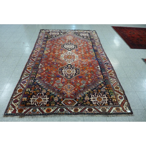 119 - An eastern red ground rug, 270 x 175cms