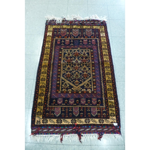 120 - A Persian Belouch Nomadic handmade rug, 86cms x 141cms